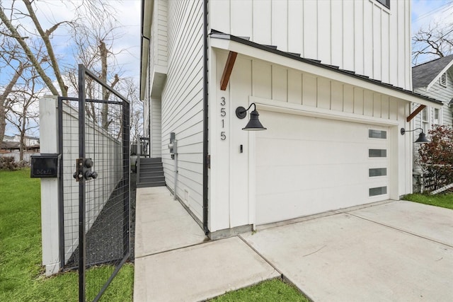 view of property exterior featuring board and batten siding, driveway, and a garage
