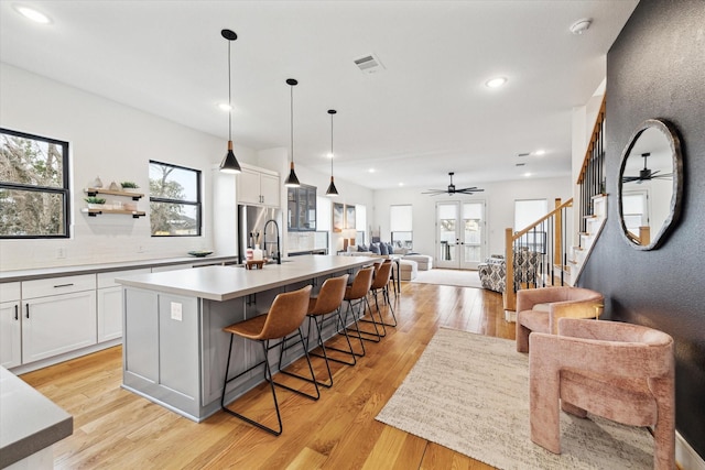 kitchen with open floor plan, decorative backsplash, healthy amount of natural light, a ceiling fan, and recessed lighting