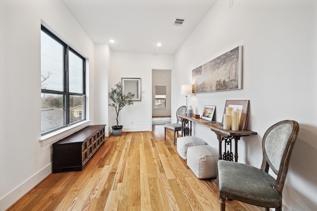 sitting room featuring light wood-style flooring, baseboards, and recessed lighting