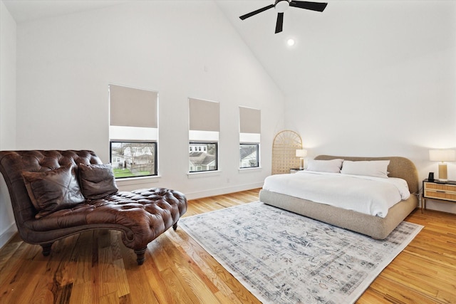 bedroom with high vaulted ceiling, light wood-style flooring, a ceiling fan, recessed lighting, and baseboards