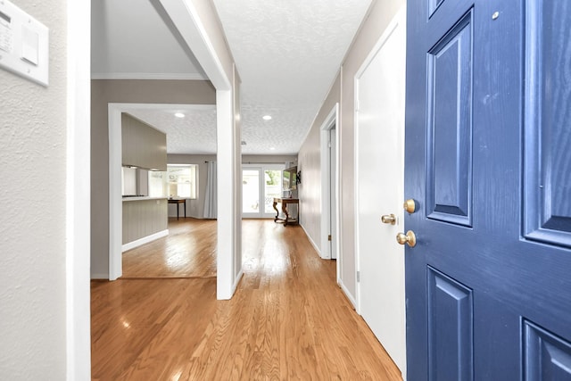 1815 Tannehill Dr, Houston, TX 77008 - entryway with light wood-type flooring, a textured ceiling, and baseboards