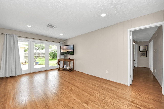 1815 Tannehill Dr, Houston, TX 77008 - empty room with attic access, light wood-type flooring, a textured ceiling, recessed lighting, and baseboards