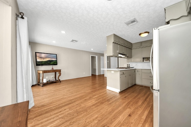 1815 Tannehill Dr, Houston, TX 77008 - kitchen featuring gray cabinetry, appliances with stainless steel finishes, a peninsula, light wood-style floors, and open floor plan