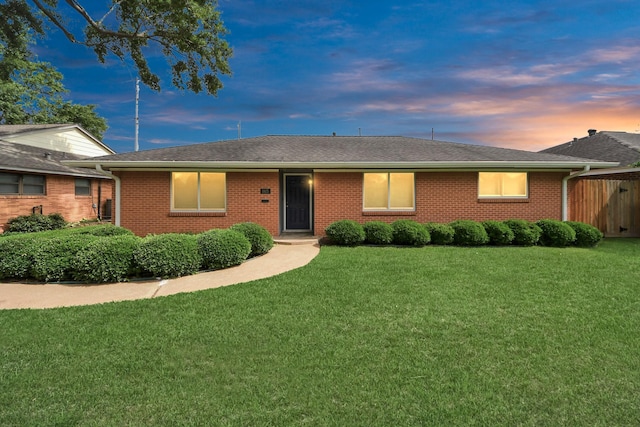 1815 Tannehill Dr, Houston, TX 77008 - ranch-style house with a yard, roof with shingles, and brick siding