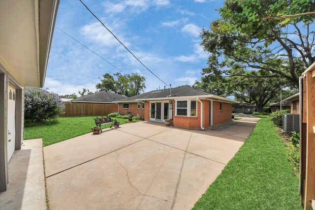 1815 Tannehill Dr, Houston, TX 77008 - back of house featuring brick siding, a patio, and central AC unit