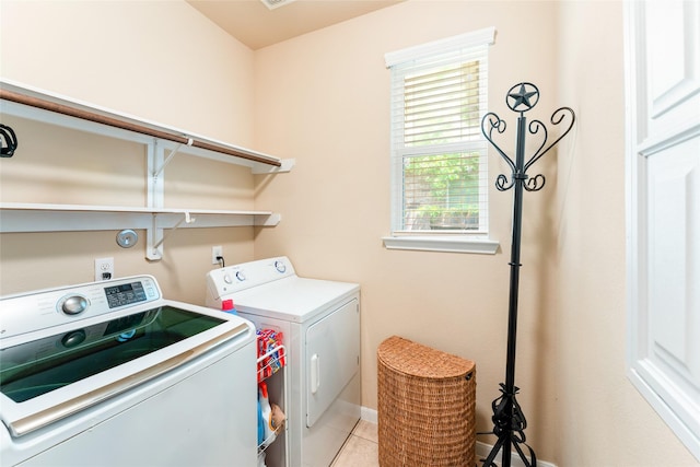 9967 Manor Spring Ln, Brookshire, TX 77423 - clothes washing area with washer and clothes dryer, baseboards, and light tile patterned floors
