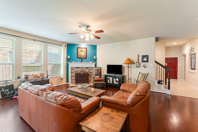 9967 Manor Spring Ln, Brookshire, TX 77423 - living area featuring a ceiling fan, hardwood / wood-style flooring, a fireplace, stairway, and baseboards