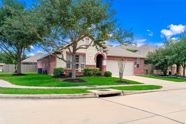9967 Manor Spring Ln, Brookshire, TX 77423 - traditional-style home featuring cooling unit, a garage, brick siding, driveway, and stone siding
