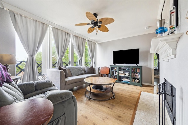 2333 Bering Dr Unit 236, Houston, TX 77057 - living area featuring crown molding, wood finished floors, ceiling fan, a fireplace with flush hearth, and baseboards