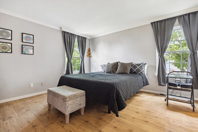 2333 Bering Dr Unit 236, Houston, TX 77057 - bedroom with crown molding, multiple windows, baseboards, and light wood-type flooring