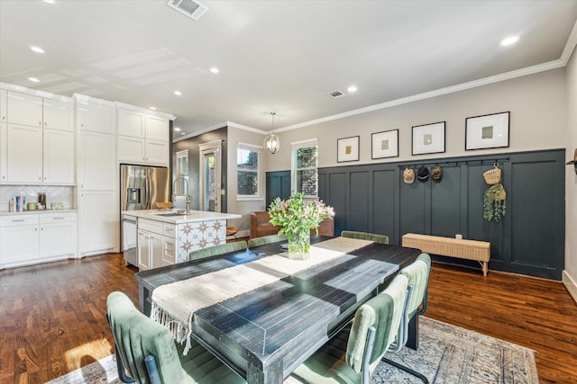 1004 Enid St Unit B, Houston, TX 77009 - dining room featuring dark wood-style flooring, recessed lighting, a wainscoted wall, ornamental molding, and a decorative wall
