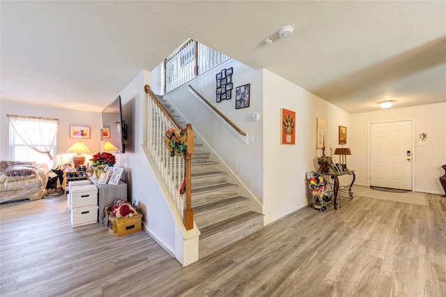1414 Stevens Ct, Rosenberg, TX 77471 - stairway with wood finished floors and baseboards