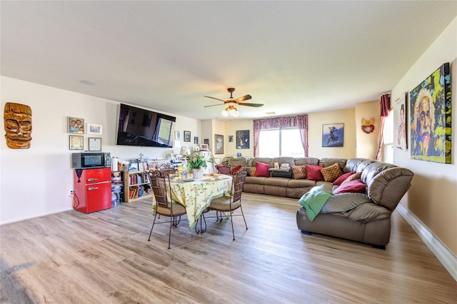 1414 Stevens Ct, Rosenberg, TX 77471 - living room with wood finished floors, a ceiling fan, and baseboards