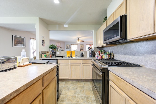 1414 Stevens Ct, Rosenberg, TX 77471 - kitchen featuring appliances with stainless steel finishes, a sink, light brown cabinets, and light countertops