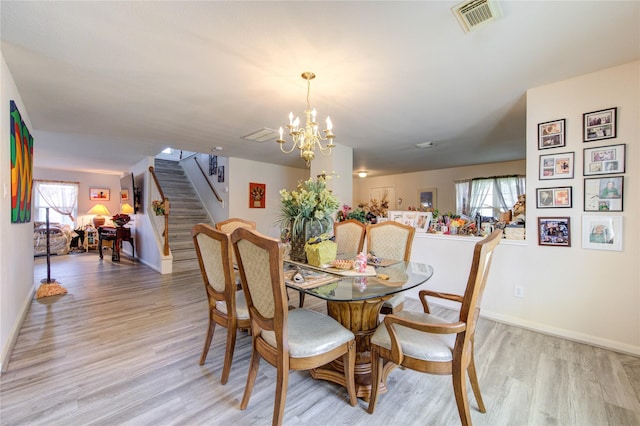 1414 Stevens Ct, Rosenberg, TX 77471 - dining room with stairway, light wood-style flooring, plenty of natural light, and a chandelier