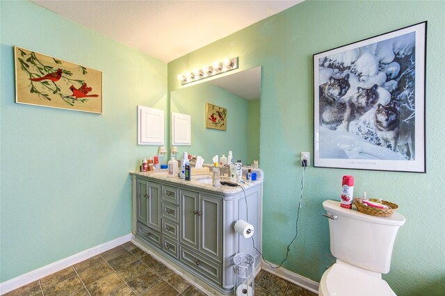 1414 Stevens Ct, Rosenberg, TX 77471 - bathroom with baseboards, toilet, and double vanity