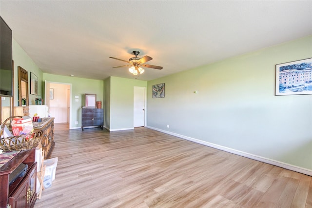1414 Stevens Ct, Rosenberg, TX 77471 - living room featuring light wood finished floors, baseboards, and a ceiling fan