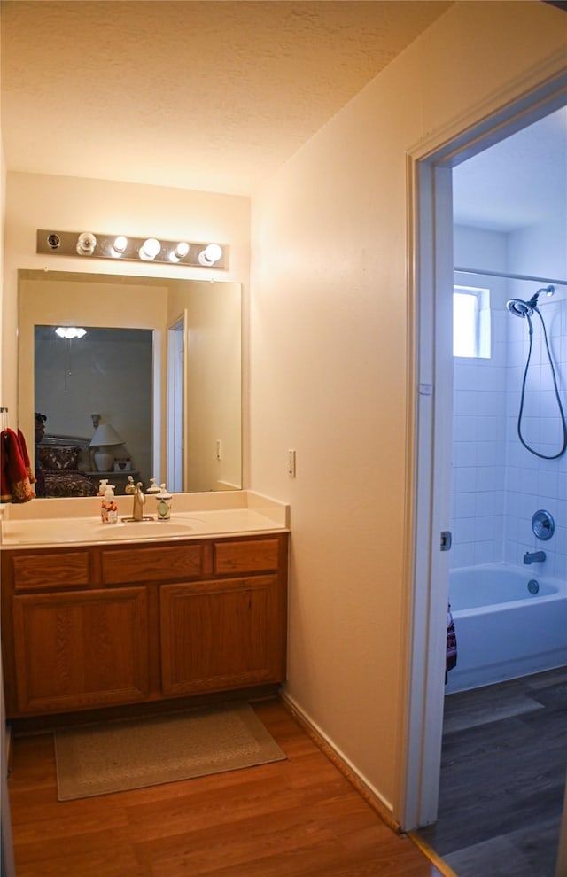 11831 Meadow Place Dr, Houston, TX 77071 - bathroom featuring vanity, wood finished floors, shower / washtub combination, and baseboards