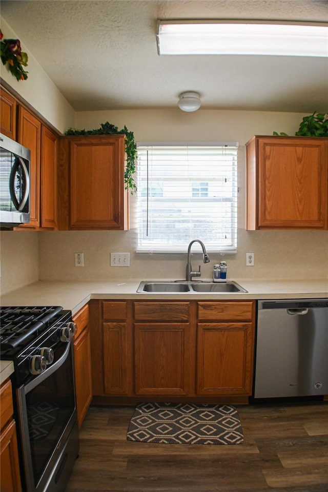 11831 Meadow Place Dr, Houston, TX 77071 - kitchen with stainless steel appliances, a sink, dark wood-style flooring, and light countertops
