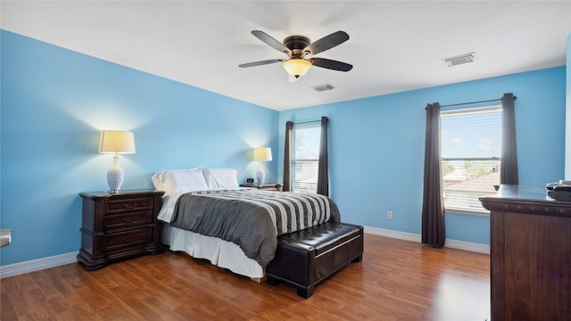5923 W Harrow Dr, Houston, TX 77084 - bedroom with wood finished floors, multiple windows, and a ceiling fan