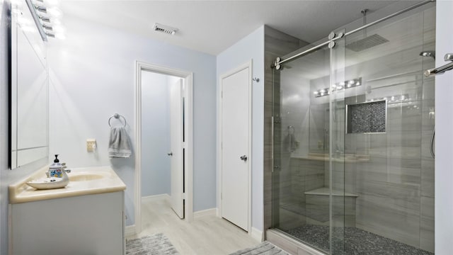 5923 W Harrow Dr, Houston, TX 77084 - bathroom with a stall shower, vanity, and wood finished floors