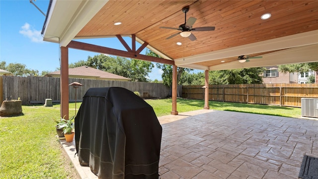 5923 W Harrow Dr, Houston, TX 77084 - fenced backyard with a ceiling fan, a patio area, and a grill