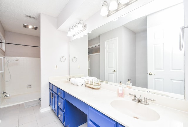 18143 Bal Harbour Dr, Houston, TX 77058 - bathroom featuring tile patterned flooring, shower / bath combination, double vanity, a textured ceiling, and baseboards