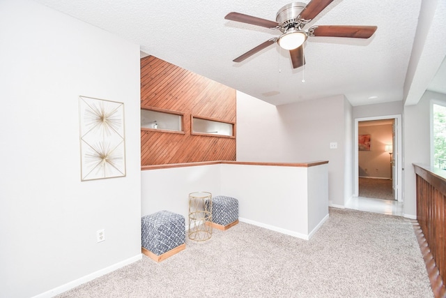 18143 Bal Harbour Dr, Houston, TX 77058 - unfurnished room featuring wood walls, carpet floors, baseboards, ceiling fan, and a textured ceiling