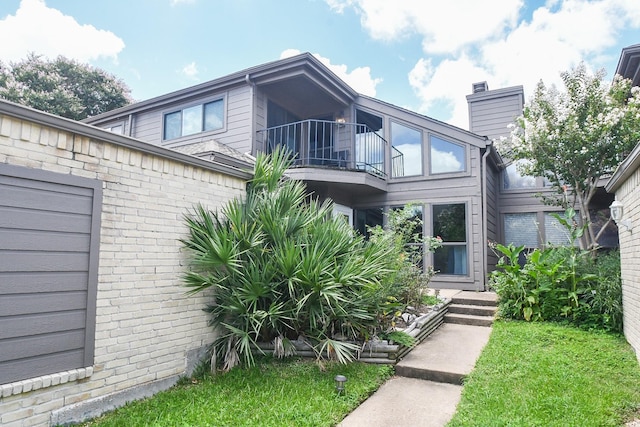 18143 Bal Harbour Dr, Houston, TX 77058 - entrance to property featuring a balcony, brick siding, and a chimney