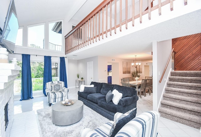 18143 Bal Harbour Dr, Houston, TX 77058 - living room with stairway, a high ceiling, a chandelier, baseboards, and tile patterned floors