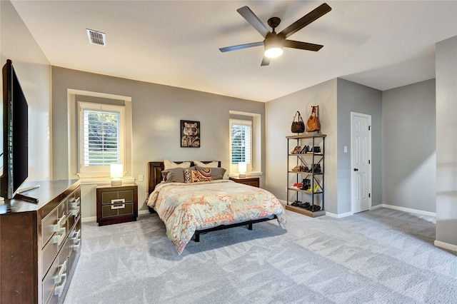 bedroom with baseboards, light carpet, multiple windows, and ceiling fan