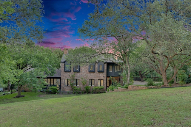 view of front of house with a front lawn and a chimney