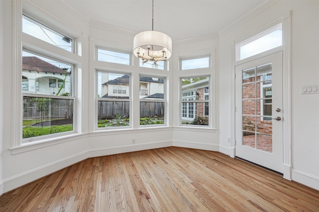 5302 Huisache St, Bellaire, TX 77401 - unfurnished sunroom with wood finished floors, baseboards, a chandelier, and crown molding
