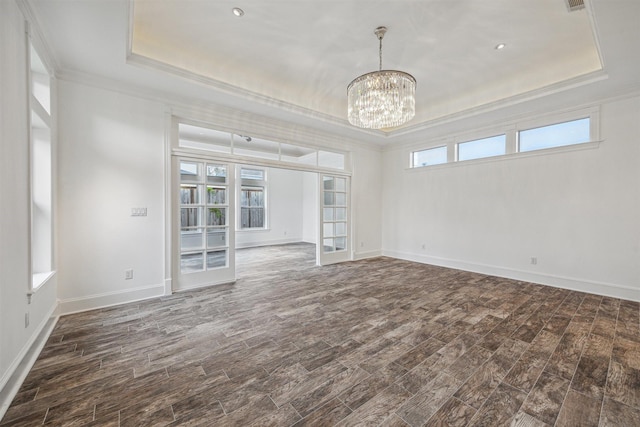 5302 Huisache St, Bellaire, TX 77401 - empty room with a tray ceiling, crown molding, a chandelier, french doors, and dark wood finished floors