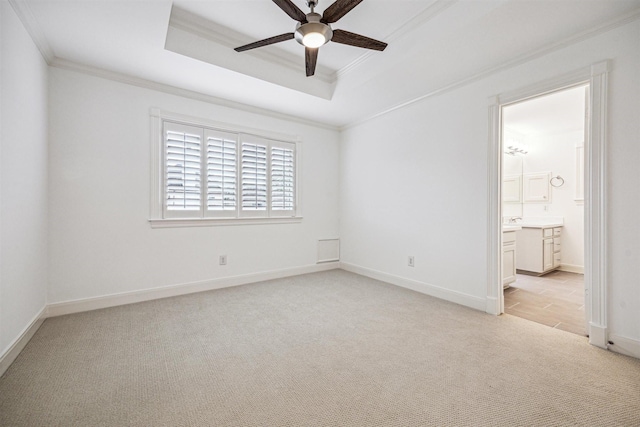5302 Huisache St, Bellaire, TX 77401 - unfurnished bedroom with light colored carpet, ornamental molding, a raised ceiling, baseboards, and connected bathroom