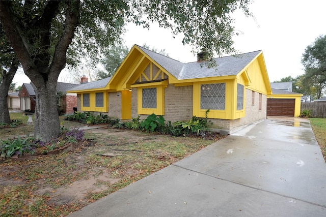12323 Bexley Dr, Houston, TX 77099 - view of front facade with brick siding, an attached garage, board and batten siding, roof with shingles, and driveway