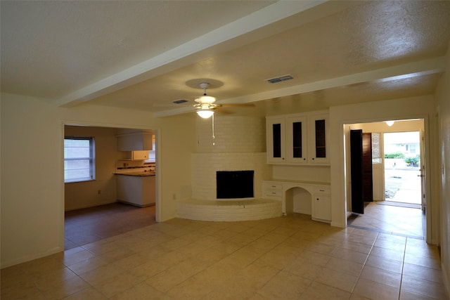12323 Bexley Dr, Houston, TX 77099 - unfurnished living room featuring a fireplace, light tile patterned floors, ceiling fan, beamed ceiling, and baseboards