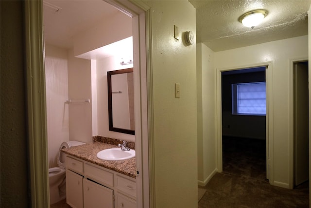 12323 Bexley Dr, Houston, TX 77099 - bathroom featuring vanity, toilet, baseboards, and a textured ceiling