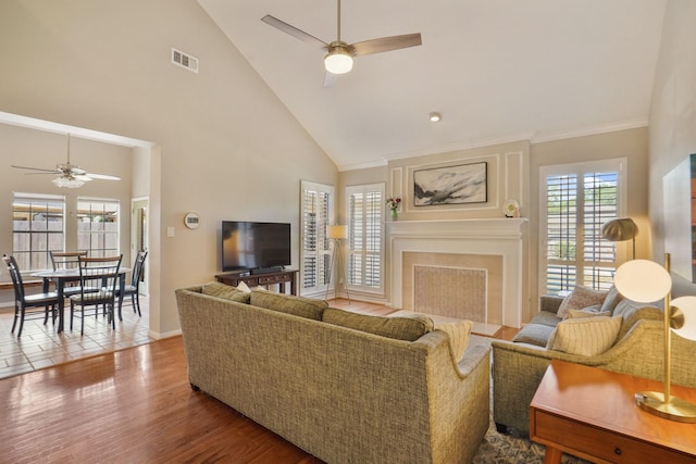 3303 Quiet Lake Dr, Katy, TX 77450 - living room with ceiling fan, wood finished floors, high vaulted ceiling, a fireplace with flush hearth, and baseboards