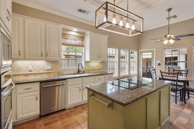 3303 Quiet Lake Dr, Katy, TX 77450 - kitchen with stainless steel appliances, a sink, tasteful backsplash, a center island, and dark stone countertops