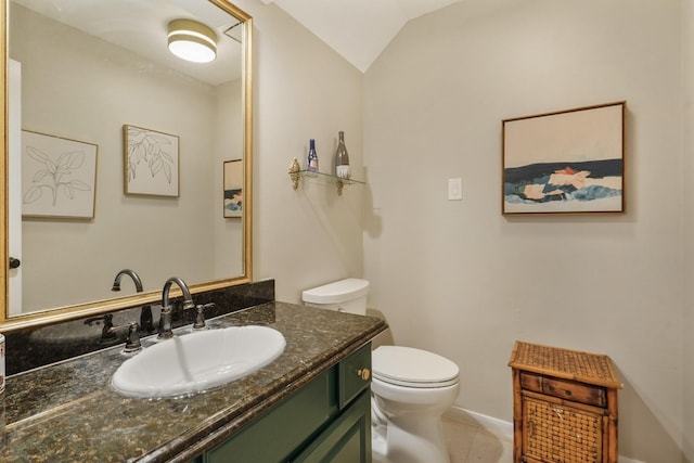 3303 Quiet Lake Dr, Katy, TX 77450 - bathroom with toilet, vanity, vaulted ceiling, tile patterned floors, and baseboards