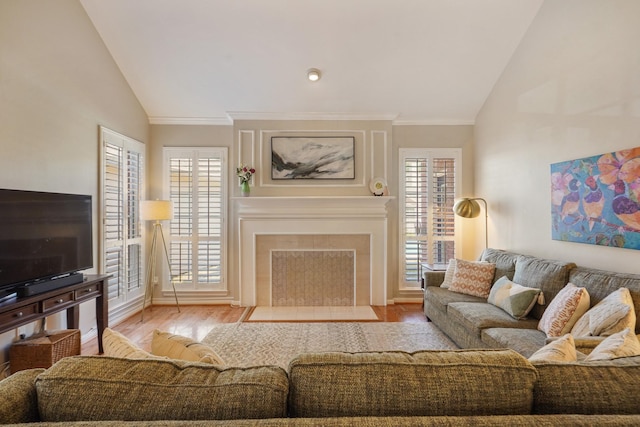 3303 Quiet Lake Dr, Katy, TX 77450 - living area with lofted ceiling, a fireplace with flush hearth, ornamental molding, wood finished floors, and plenty of natural light