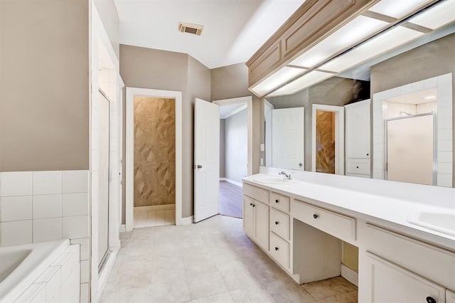 2514 Thunderbird Dr, Orange, TX 77630 - bathroom featuring double vanity, a shower stall, a bath, and tile patterned floors