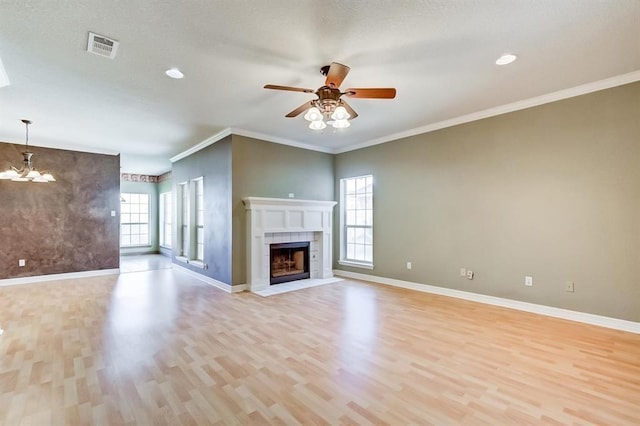 2514 Thunderbird Dr, Orange, TX 77630 - unfurnished living room featuring light wood-type flooring, ceiling fan, a tile fireplace, a chandelier, and ornamental molding