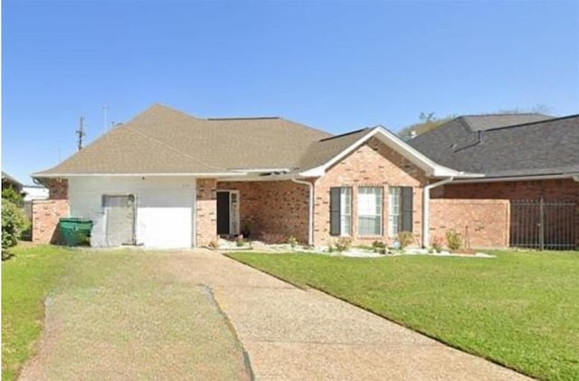 2514 Thunderbird Dr, Orange, TX 77630 - single story home with concrete driveway, a garage, and brick siding