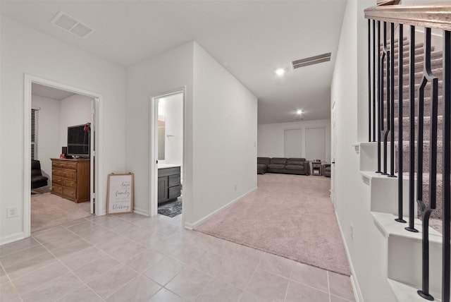 2897 Shimmer Edge Dr, Katy, TX 77493 - hallway featuring light carpet, light tile patterned flooring, recessed lighting, and baseboards