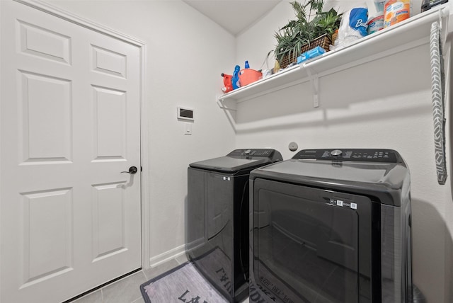 2897 Shimmer Edge Dr, Katy, TX 77493 - laundry room featuring washer and clothes dryer, tile patterned flooring, and baseboards