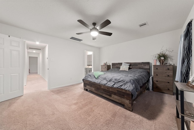 2897 Shimmer Edge Dr, Katy, TX 77493 - bedroom with light colored carpet, baseboards, ensuite bath, a ceiling fan, and a textured ceiling