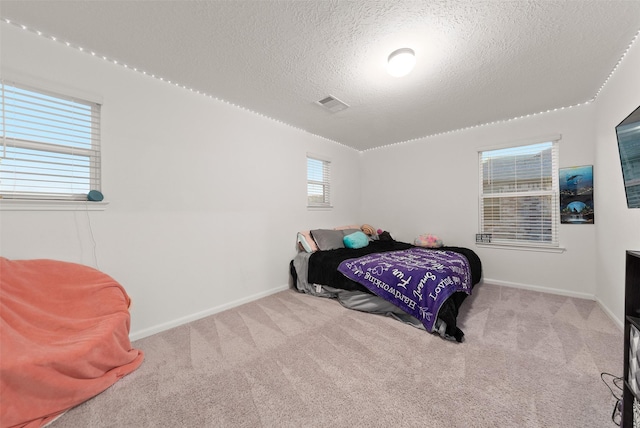 2897 Shimmer Edge Dr, Katy, TX 77493 - carpeted bedroom featuring a textured ceiling and baseboards