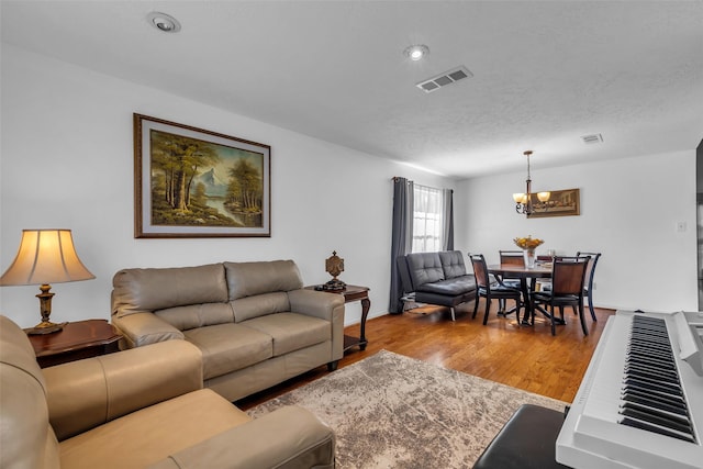 16222 Indian Cypress Dr, Cypress, TX 77429 - living room with a chandelier, wood finished floors, and a textured ceiling
